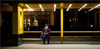 Young person waiting for a train